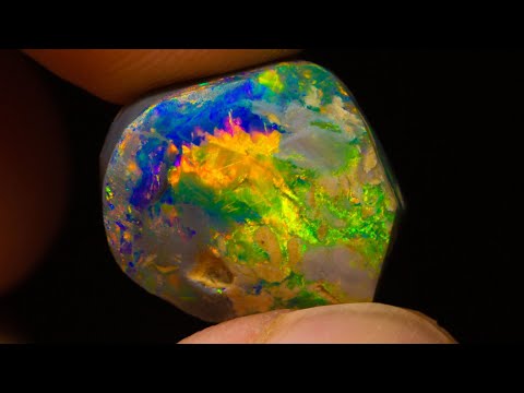 $20k gem black opal emerges from this uncut rough opal