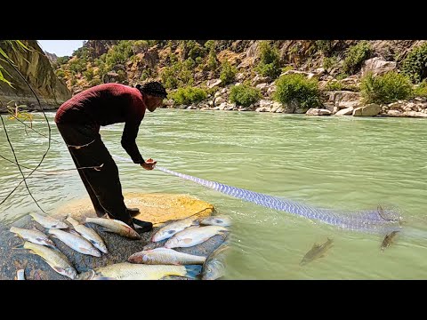 Thumbnail for Nomadic man all Alone in a huge River, Looking for Fish