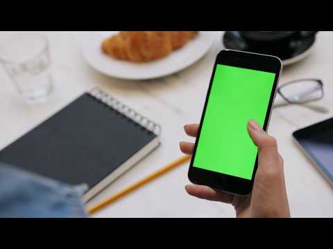 Thumbnail for woman using smartphone with green screen close up video of womans hands scrolling pages on mobile ph
